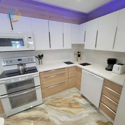 a kitchen with white cabinets and a stove top oven at Alexander 821 in Miami Beach