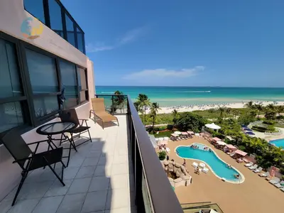 a balcony with a view of the beach and the ocean at Alexander 901 in Miami Beach