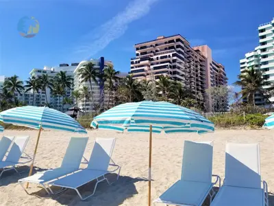 a group of chairs and umbrellas on a beach at Alexander 901 in Miami Beach