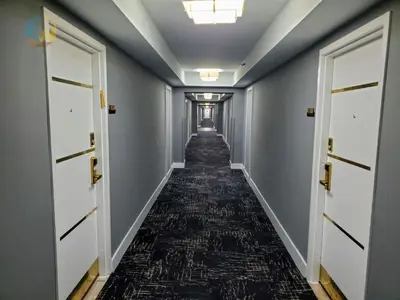 a corridor with doors and a carpeted hallway at Alexander in Miami Beach