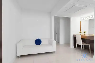 a white living room with a white couch and a table at Apartment 2BR 2BTH - Free Parking in Sunny Isles Beach