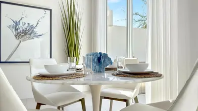 a white dining room with a table and chairs at Tiffany Tides - Resort-Style Beach Townhome - Gym, Rooftop Pool and Sauna in Fort Lauderdale