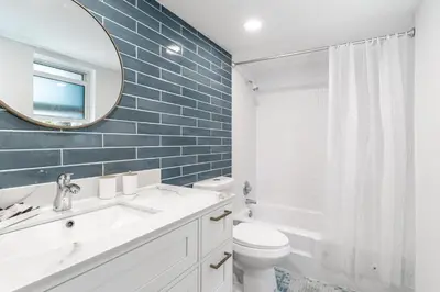a bathroom with a sink and a toilet and a mirror at Serenity Homes in Fort Lauderdale