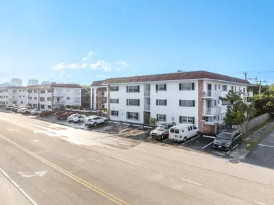 an empty street with cars parked in a parking lot at Serenity Homes in Fort Lauderdale