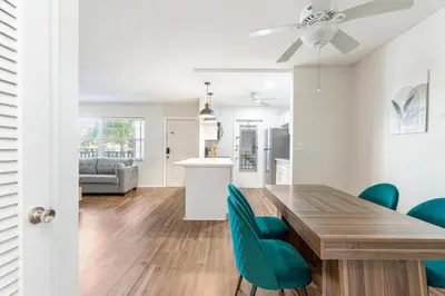 a dining room and living room with a table and chairs at Serenity Homes in Fort Lauderdale