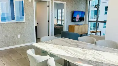 a dining room with a table and chairs at Rare Corner Unit Private Terrace & Sunset Views in Miami