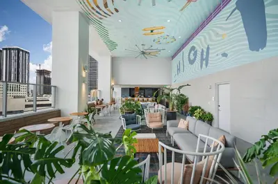 a restaurant with plants and chairs on a balcony at Rare Corner Unit Private Terrace & Sunset Views in Miami