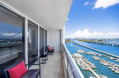 a balcony with chairs and a view of a marina at The Grand Wonder Biscayne in Miami