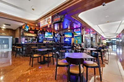 a bar with tables and chairs in a restaurant at The Grand Wonder Biscayne in Miami