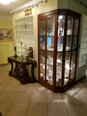 a room with a china cabinet and a table in it at Flats Hospitality in Plantation