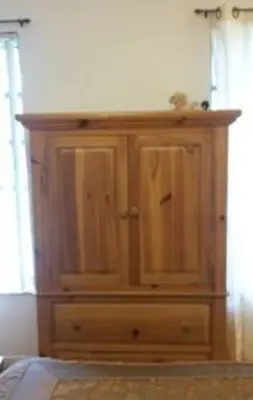 a wooden cabinet in the corner of a room at Flats Hospitality in Plantation