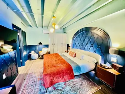 a bedroom with a large bed with a large headboard at Double Rainbow Suites 24th in Fort Lauderdale