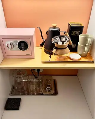 a shelf with a microwave and a coffee maker and a tea pot at Double Rainbow Suites 24th in Fort Lauderdale
