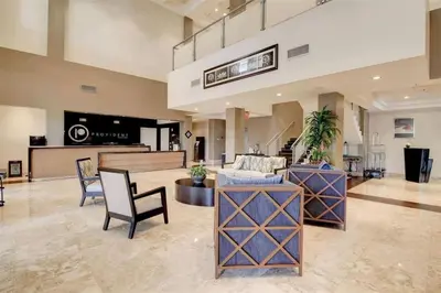 a lobby with a couch and a table and chairs at Stylish Apartment 1BR - 2BTH in Miami