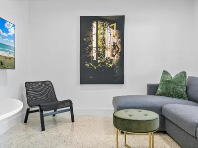 a living room with a couch and a chair at Hidden Gem Studio Near Wynwood & Beaches in Miami