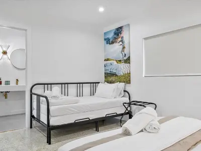 two beds in a room with a picture on the wall at Hidden Gem Studio Near Wynwood & Beaches in Miami