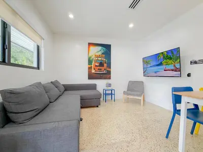 a living room with a couch and a table at Designer 1BR Retreat Heart of Miami Pool in Miami