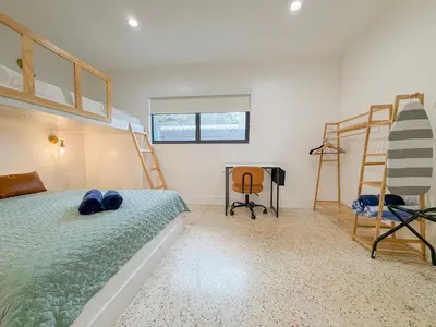 a bedroom with two bunk beds and a desk at Designer 1BR Retreat Heart of Miami Pool in Miami