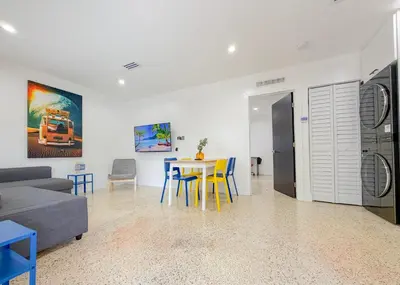 a living room with a table and chairs and a couch at Designer 1BR Retreat Heart of Miami Pool in Miami