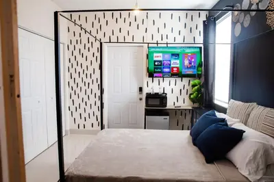 a bedroom with a bed and a tv in it at Boho Oasis 2 in Homestead