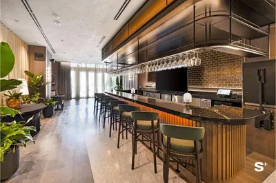 a bar in a restaurant with a bunch of stools at Skyline 1-BD Condo - City & Ocean View in Miami