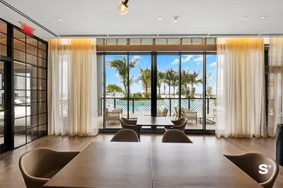 a conference room with a table and chairs and a view of the ocean at Skyline 1-BD Condo - City & Ocean View in Miami
