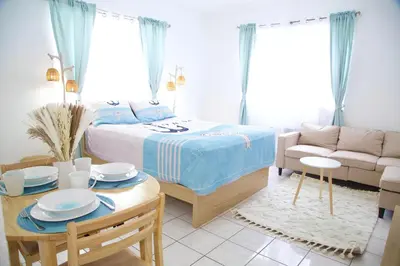a bedroom with a bed and a table and a couch at Miami2 Beach Stay 3 min to Ocean in Miami Beach
