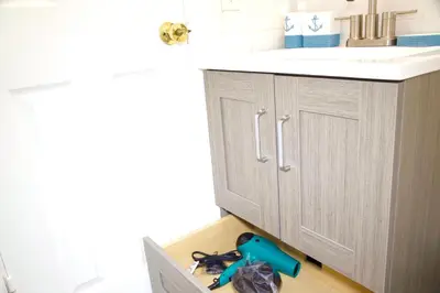 a bathroom with a sink and a bunch of tools in a drawer at Miami2 Beach Stay 3 min to Ocean in Miami Beach