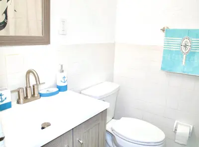 a bathroom with a toilet and a sink at Miami2 Beach Stay 3 min to Ocean in Miami Beach