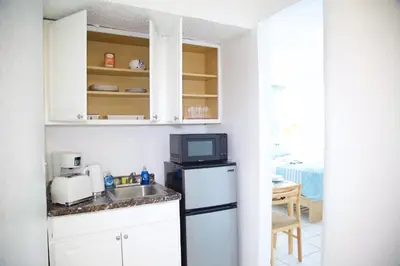 a kitchen with a sink and a microwave at Miami2 Beach Stay 3 min to Ocean in Miami Beach