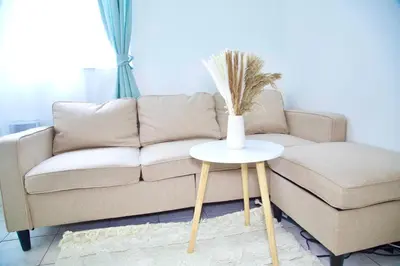 a living room with a couch and a vase on a table at Miami2 Beach Stay 3 min to Ocean in Miami Beach