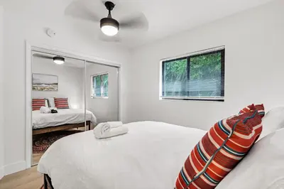 a white bedroom with two beds and a mirror at Rent in Fort Lauderdale near Broward Medical in Fort Lauderdale