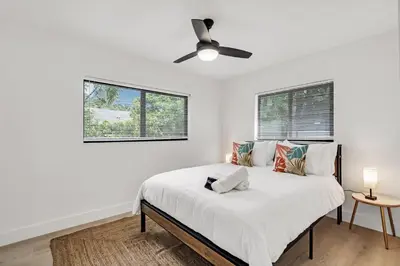 a white bedroom with a bed with a ceiling fan at Rent in Fort Lauderdale near Broward Medical in Fort Lauderdale