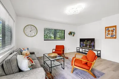 a living room with a couch and two chairs and a clock at Rent in Fort Lauderdale near Broward Medical in Fort Lauderdale