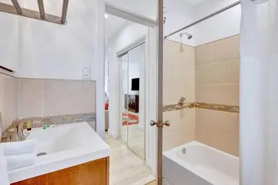 a bathroom with a tub and a sink and a shower at 320-1 Las Olas Boulevard in Fort Lauderdale