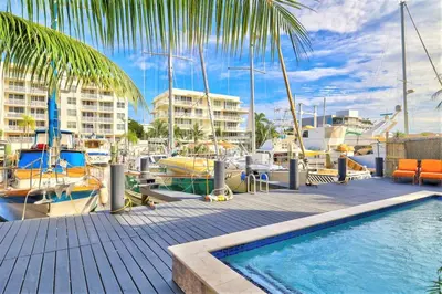 a swimming pool next to a marina with boats at 320-1 Las Olas Boulevard in Fort Lauderdale