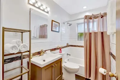 a bathroom with a sink and a toilet and a tub at 320-1 Las Olas Boulevard in Fort Lauderdale
