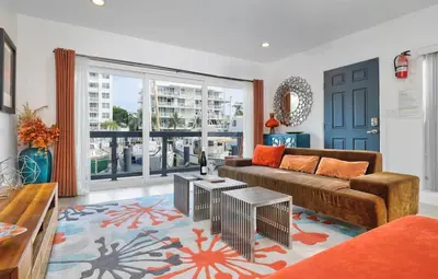 a living room with a couch and a large window at Orange Dream on the Water in Fort Lauderdale
