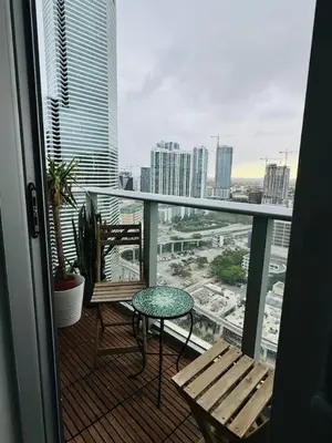 a balcony with a table and chairs and a view of a city at Art-filled Loft 180 Views, Rooftop Pool, Parking in Miami