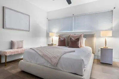 a white bedroom with a large bed with two lamps at Luxury Miami Villa with Large Pool & BBQ, Perfect Getaway! in Miami
