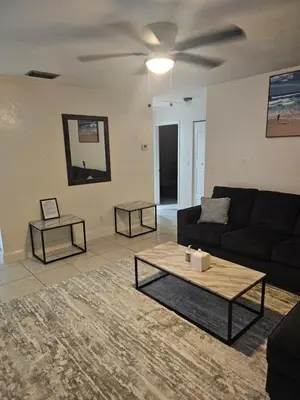 a living room with a couch and a table at Hollywood Happiness in Hollywood