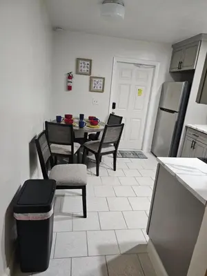 a kitchen with a table and chairs and a refrigerator at Hollywood Happiness in Hollywood