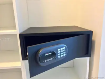 a microwave oven with a safe in a cabinet at Splendid apartment for 4 pax partial view of the beach in Hollywood M in Hollywood