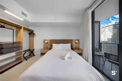 a bedroom with a large bed and a large window at Modern DTW Miami Escape with Water Views in Miami