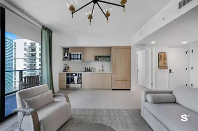a living room with a couch and a kitchen at Modern DTW Miami Escape with Water Views in Miami