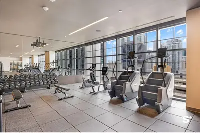 a gym with treadmills and ellipticals in a building at Upscale 1-BD Condo in DTW Miami - City Views in Miami