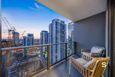 a balcony with two chairs and a view of a city at Luxury 1-BD with Breathtaking Downtown Views in Miami
