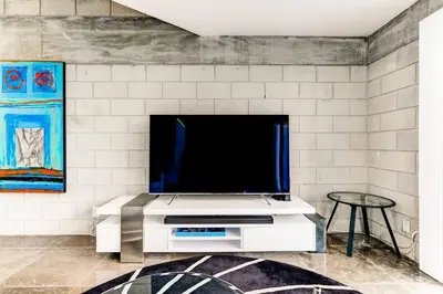 a living room with a tv on a white wall at Entire townhouse Ft Lauderdale in Fort Lauderdale