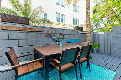 a wooden table and chairs on a patio at Entire townhouse Ft Lauderdale in Fort Lauderdale