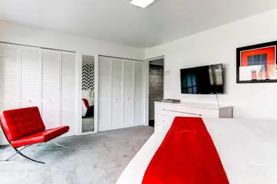 a bedroom with a red bed and a red chair at Entire townhouse Ft Lauderdale in Fort Lauderdale